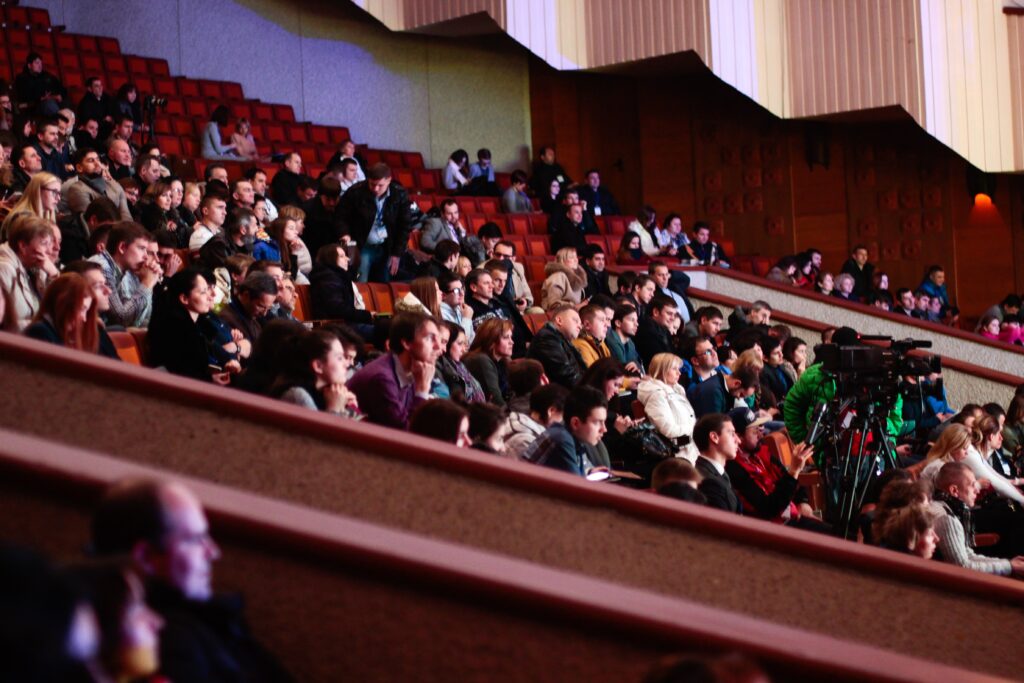 An audience sitting in a theatre